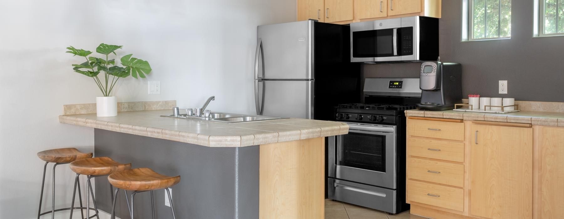 community kitchen with a table and stools