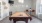 a room with a pool table and chairs